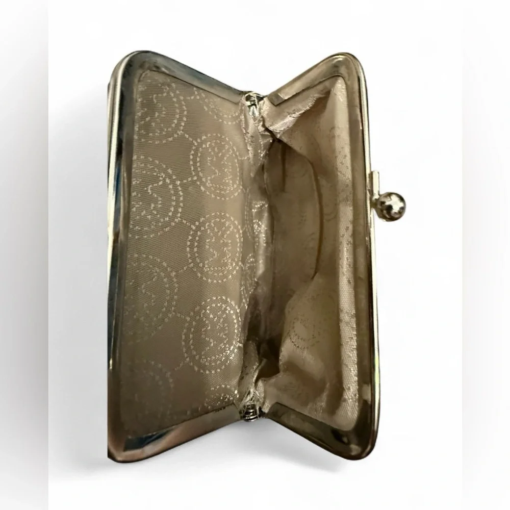 Michael Kors signature white and gray change purse with a clasp closure